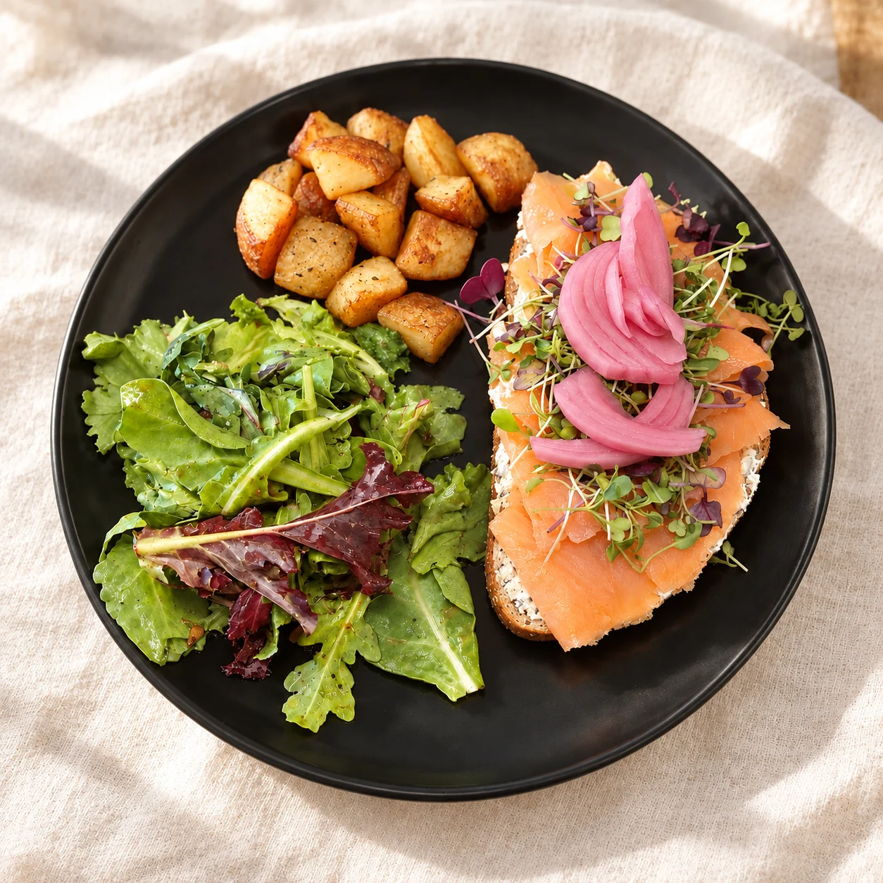 Smoked salmon toast with salad and roasted potatoes.